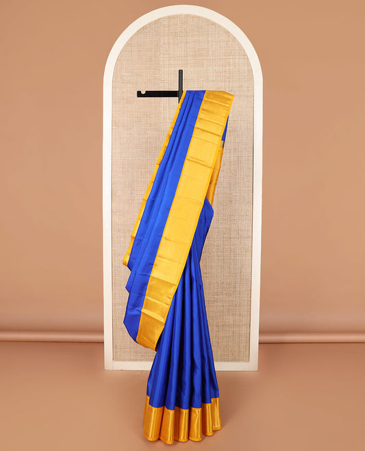 Royal blue plain Kanchipuram silk saree, contrast border of salngai, muthu, and ara maadam designs, and intricate pallu