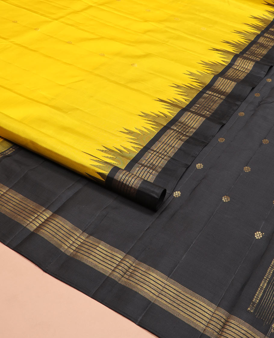 Yellow zari buttas Kanchipuram silk saree, contrast thazampoo rekku zari border, and pallu features kamalam designs