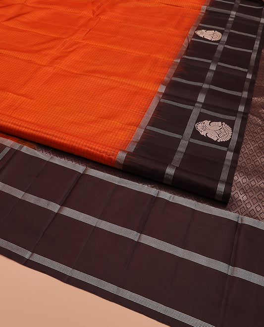 Orange Kanchipuram Silk Saree Sparsely Sparkled Checks on Its Body, Complemented by a Contrast Border of Iruthalai Pakshi Butta Enclosed Checks, Gleaming Pallu of Jaal Designs, and Paired with a Contrast Blouse