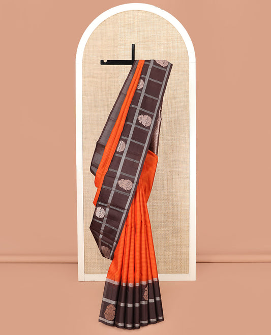 Orange Kanchipuram Silk Saree Sparsely Sparkled Checks on Its Body, Complemented by a Contrast Border of Iruthalai Pakshi Butta Enclosed Checks, Gleaming Pallu of Jaal Designs, and Paired with a Contrast Blouse