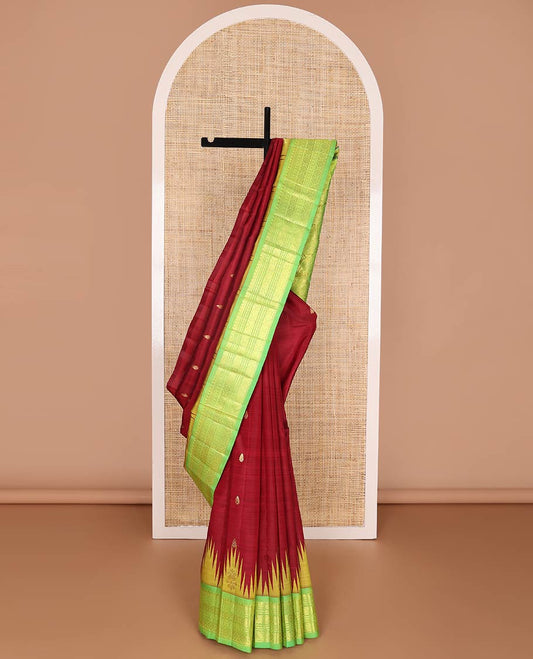 Red kancheepuram silk saree with zari buttas, contrast one-sided thazampoo reku border of salngai,banaras,kattu thuthirippu & laddu kamalam & floral design pallu