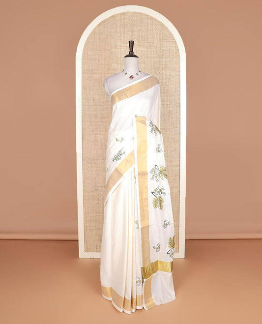Cream floral motifs embroidered Kerala cotton saree, bavanji border, and floral motifs embroidered pallu