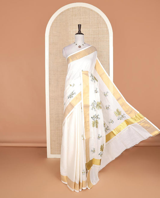 Cream floral motifs embroidered Kerala cotton saree, bavanji border, and floral motifs embroidered pallu