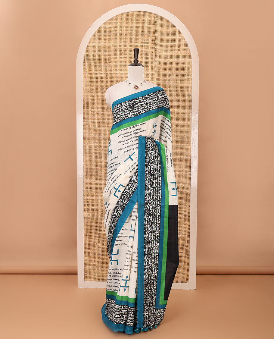 Chikku color swastika & Hindi typography printed jute cotton saree, contrast printed border, printed pallu & plain blue blouse