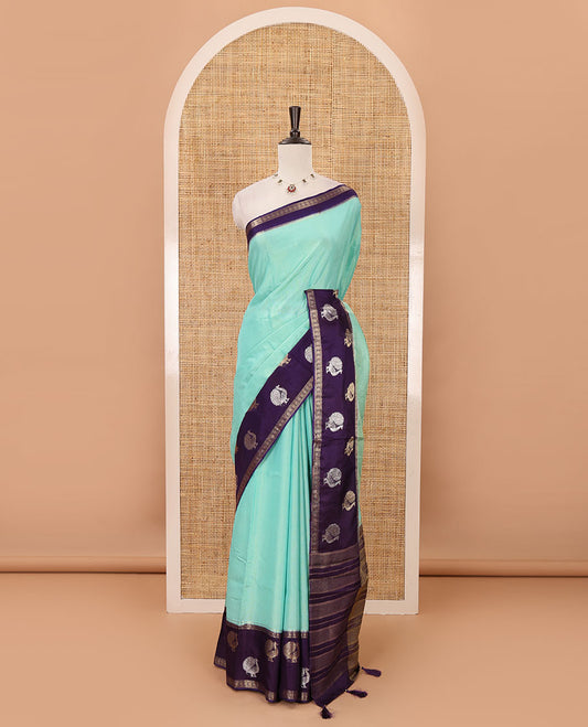 Blue plain Banarasi tissue silk saree, contrast traditional zari peacock border, zari striped pallu & floral jaal jacquard purple blouse
