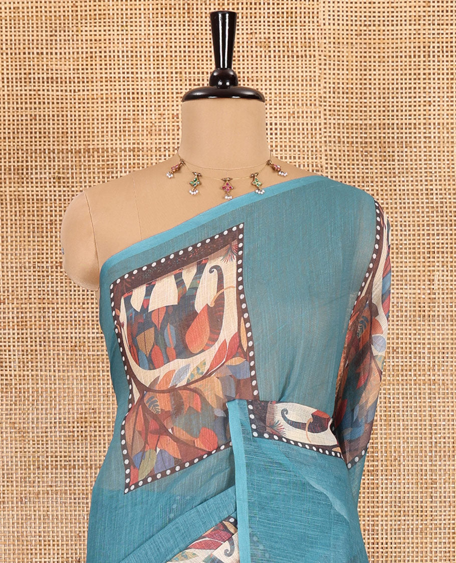 Blue plain linen cotton saree, mordern art style elephant motifs printed border, elephant printed pallu, and a leaf printed blouse
