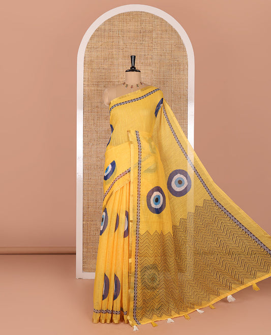 Yellow evil eye motifs printed linen cotton saree, diamond motifs printed with piping border, chevron printed pallu, and a matching blouse