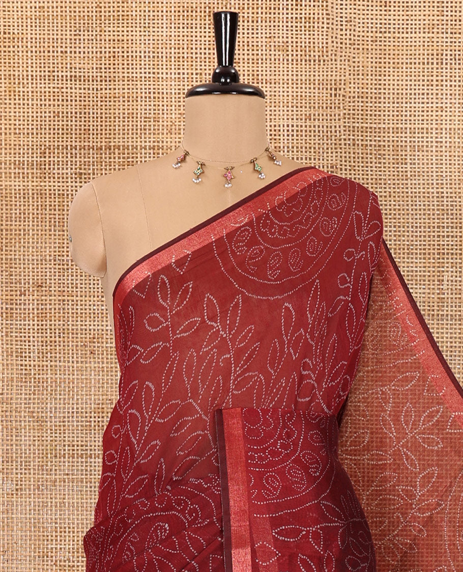 Maroon bandhani-style floral and chakra printed saree, zari piping border, contrast ajrakh printed pallu, and contrast ajrakh printed blouse