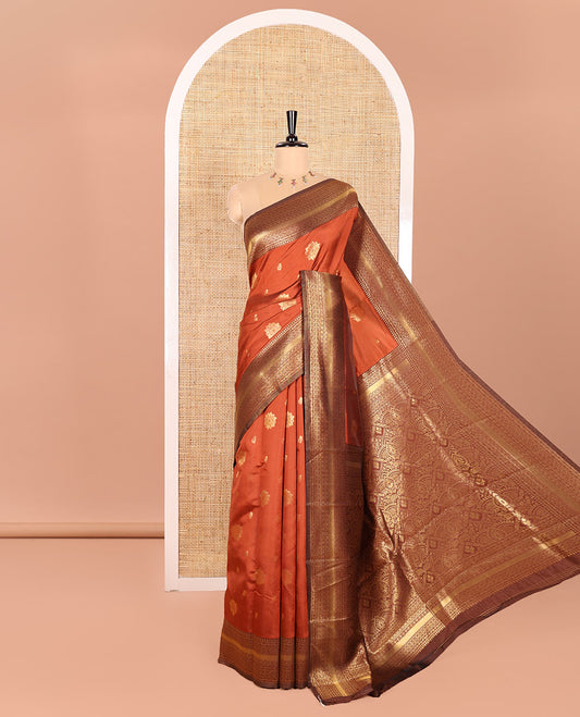 Rust Orange Kanchi Silk Saree, Beautified with Floral Zari Buttas All Over Its Body, Complemented by a Contrast Border of Traditional Zari Designs, Majestically Detailed Pallu, and Paired with a Contrast Blouse