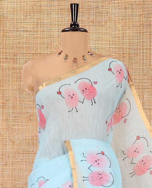 Blue Linen Cotton Saree, Creatively Printed with Thumb Finger Printed Cartoon-Theme Print on Its Body, a Subtle Piping Border, a Self-Printed Pallu, and Paired with a Matching Blouse