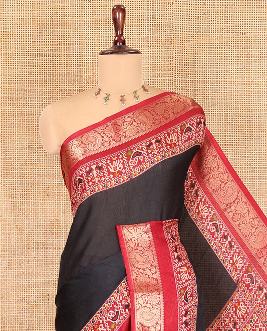 Black Embossed Moss Chiffon Saree, Complemented by a Contrast Traditional Zari Patola Printed Border, Patola Pallu, and a Contrast Blouse