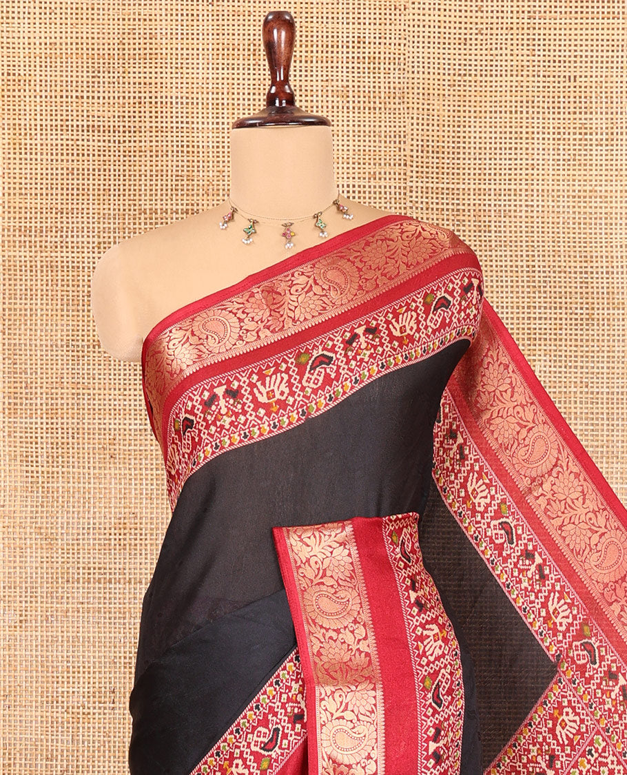 Black Embossed Moss Chiffon Saree, Complemented by a Contrast Traditional Zari Patola Printed Border, Patola Pallu, and a Contrast Blouse