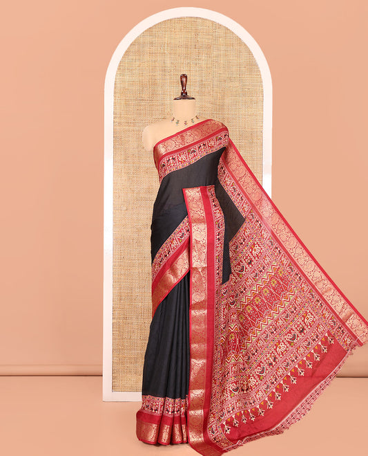 Black Embossed Moss Chiffon Saree, Complemented by a Contrast Traditional Zari Patola Printed Border, Patola Pallu, and a Contrast Blouse