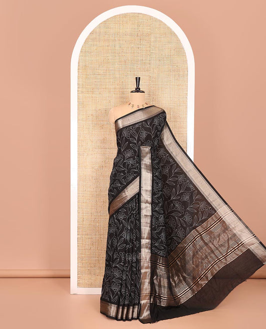 Black dotted floral discharge printed assam silk saree, chevron striped border, zari striped pallu, and a matching blouse