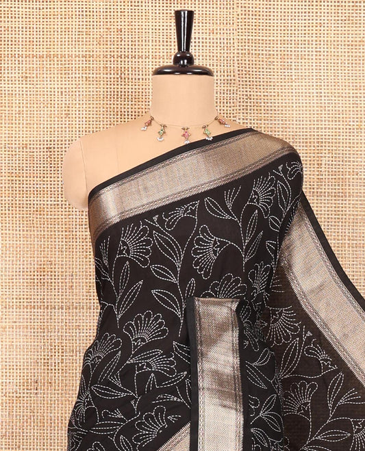 Black dotted floral discharge printed assam silk saree, chevron striped border, zari striped pallu, and a matching blouse