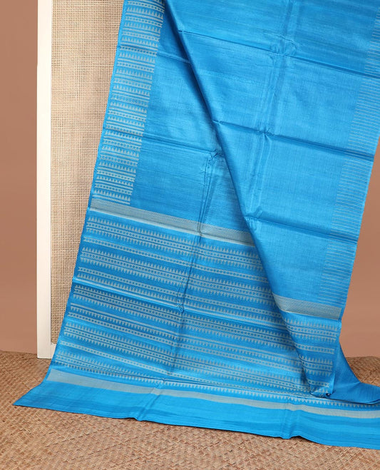 Sky blue plain tussar silk saree, self border and pallu features geometric patterns, and temple motifs