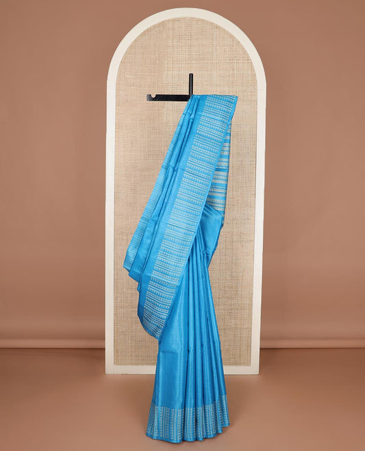 Sky blue plain tussar silk saree, self border and pallu features geometric patterns, and temple motifs