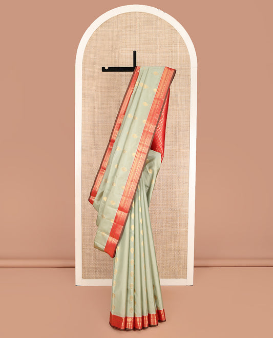 Pale Green Vasundhara Lite Silk Mix Saree, Subtly Sparkled with Zari Buttas on Its Body, Complemented by a Contrast Border of Annam and Chakram Designs, Grand Pallu of Spade Designs, and Paired with a Contrast Blouse