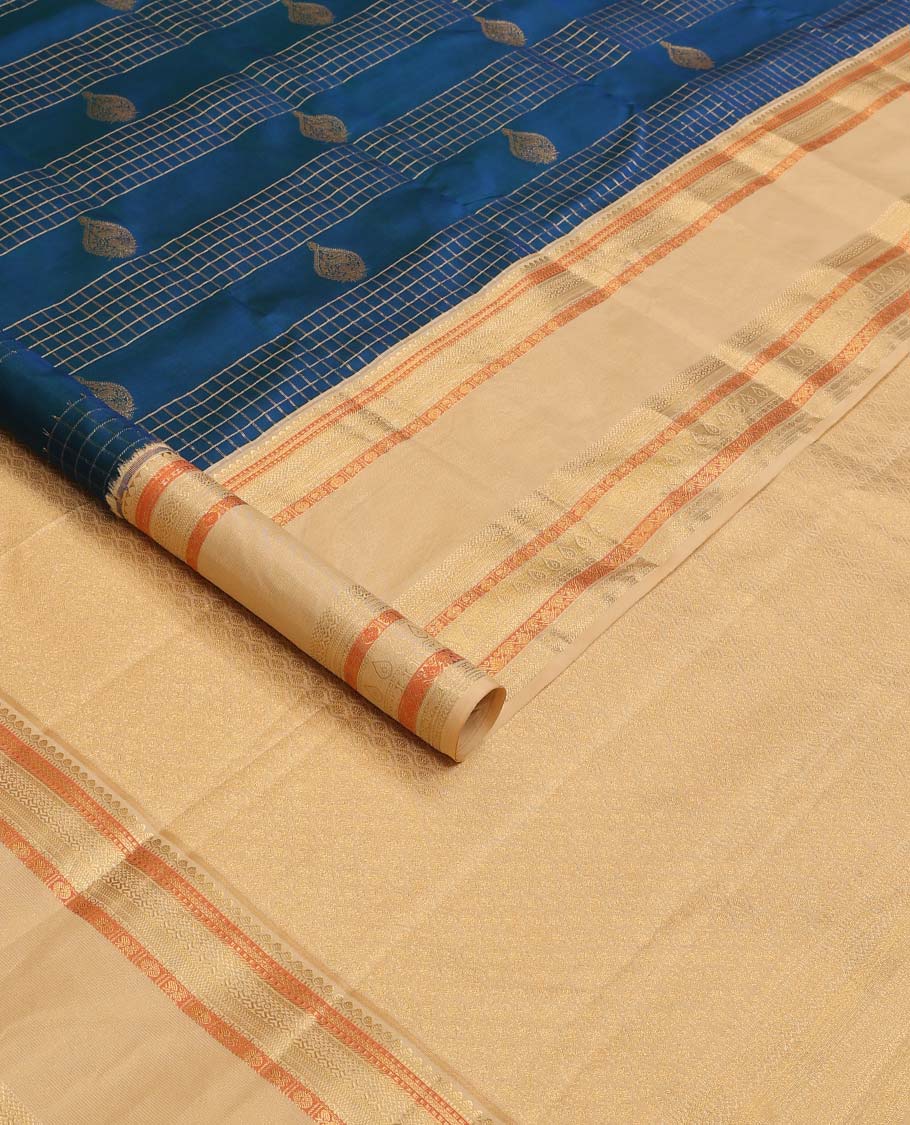 Blue zari buttas and zari checked Vasundhara silk mix saree, contrast border of thilakam, muthu, banaras, poun, and mayil designs, and then kuli kann pallu
