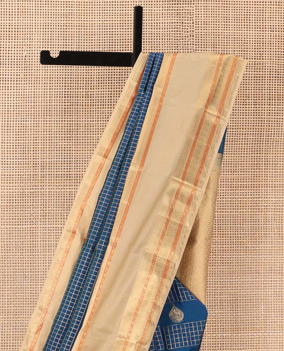 Blue zari buttas and zari checked Vasundhara silk mix saree, contrast border of thilakam, muthu, banaras, poun, and mayil designs, and then kuli kann pallu