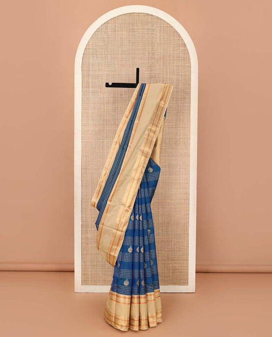 Blue zari buttas and zari checked Vasundhara silk mix saree, contrast border of thilakam, muthu, banaras, poun, and mayil designs, and then kuli kann pallu