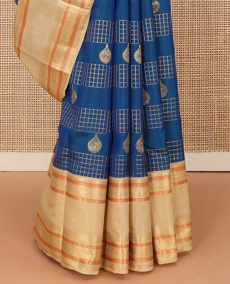 Blue zari buttas and zari checked Vasundhara silk mix saree, contrast border of thilakam, muthu, banaras, poun, and mayil designs, and then kuli kann pallu