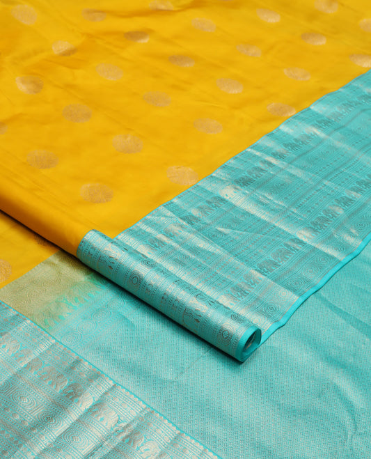 Yellow zari buttas silk saree, contrast border of thilakam mokku, poun, yaanai, chakram, and mayil kann designs, and jaal pallu