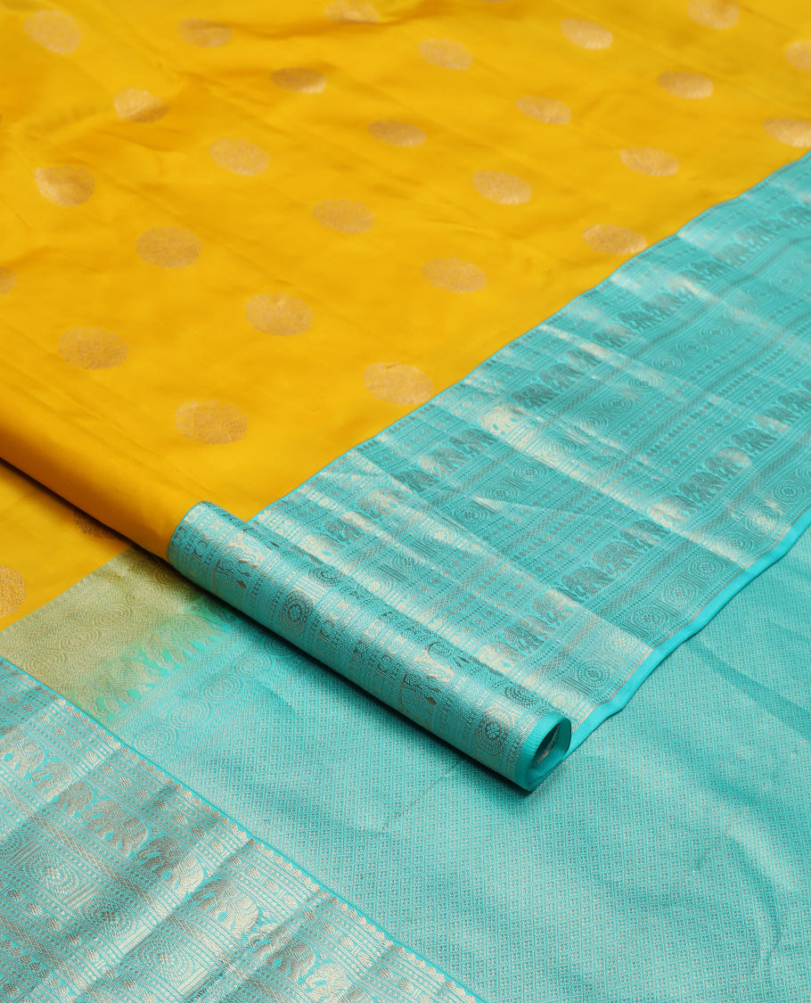 Yellow zari buttas silk saree, contrast border of thilakam mokku, poun, yaanai, chakram, and mayil kann designs, and jaal pallu