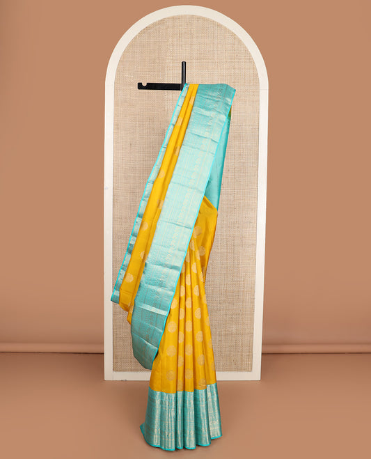 Yellow zari buttas silk saree, contrast border of thilakam mokku, poun, yaanai, chakram, and mayil kann designs, and jaal pallu