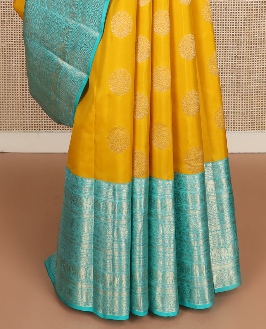 Yellow zari buttas silk saree, contrast border of thilakam mokku, poun, yaanai, chakram, and mayil kann designs, and jaal pallu