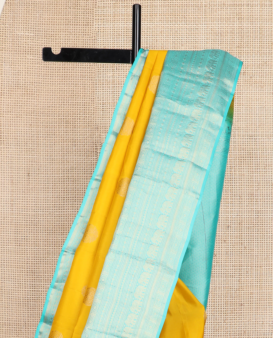 Yellow zari buttas silk saree, contrast border of thilakam mokku, poun, yaanai, chakram, and mayil kann designs, and jaal pallu