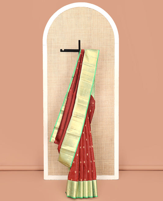 Brown Vasundhara Silk Saree, Detailed with Mayil and Chakram Buttas Enclosed Checks, Complemented by Contrast Border of Rekku, Mayil Kann, and Mayil Manga Designs, Grand Jaal Pallu and Paired with a Contrast Blouse