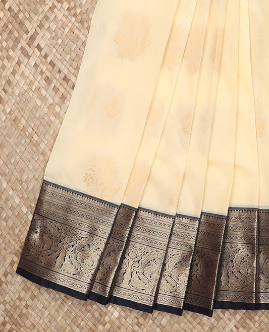 Cream butta enclosed checked budget silk saree, contrast traditional zari border, and intricate pallu