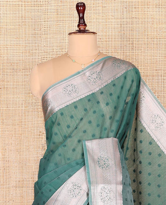 Blue Semi-Silk Cotton Saree, Sparsely Woven with Floral Buttas on Its Body, Highlighted by a Zari Traditional Border, Geometric Patterned Pallu, and Paired with a Matching Blouse