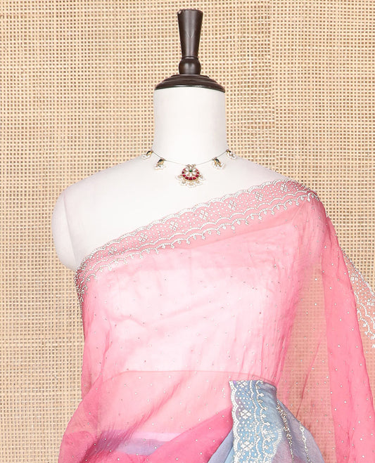 Pink embroidered designer saree with stones embedded in its body, contrast scallop stone work border