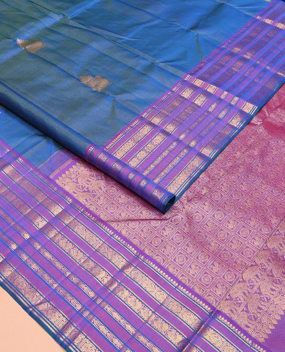 Blue striped and mayil buttas Kanchipuram silk saree, contrast border of thilakam mokku, mayil, and meen designs and annam chakram butta enclosed checked pallu
