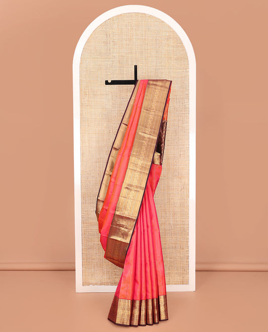 Pink Vasundhara Silk Saree, Beautifully Bedecked with Zari Stripes on Its Body, Complemented by a Contrast Border of Thilakam Mokku, Kathir, Vanki, Mayil, and Laddu Kamalam Designs, Majestically Detailed Jaal Pallu, and Paired with a Contrast Blouse
