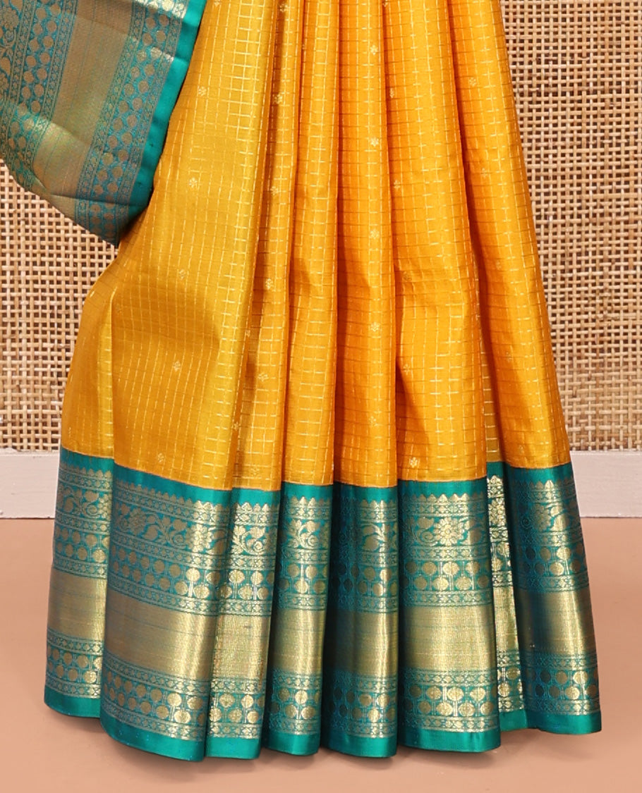 Yellow Vasundhara Silk Saree, Subtly Sparkled with Zari Buttas and Checks All Over Its Body, Complemented by a Contrast Border of Thilakam, Diamond, Kodi Visiry, and Poun Designs, Grand Pallu, and Paired with a Contrast Blouse