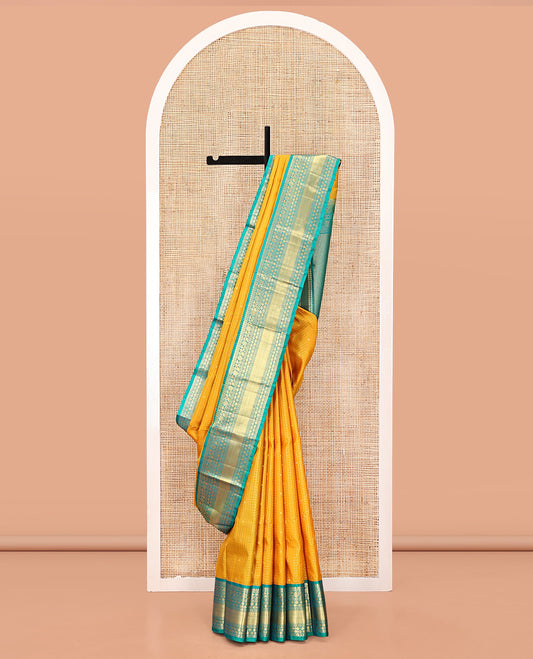 Yellow Vasundhara Silk Saree, Subtly Sparkled with Zari Buttas and Checks All Over Its Body, Complemented by a Contrast Border of Thilakam, Diamond, Kodi Visiry, and Poun Designs, Grand Pallu, and Paired with a Contrast Blouse
