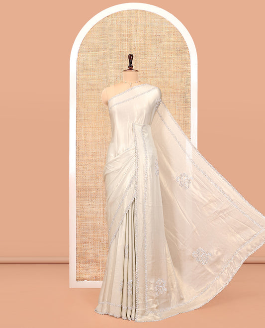 Champagne Designer Saree, Spotlighted by Zari Buttas All Over Its Body, Scallop Stone Work Border, and Paired with a Matching Blouse
