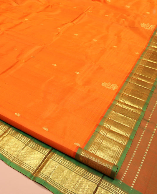 Orange Kanchipuram Silk Saree, Crafted with Zari Buttas, Complemented by a Contrast One-Sided Border of Panner Sombu, Banaras, Muthu and Mayil Kann Designs, Grand Jaal Pallu, and No Blouse