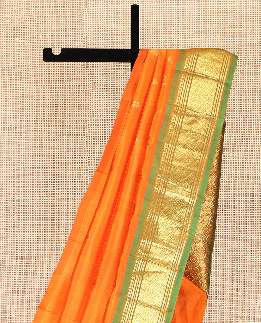 Orange Kanchipuram Silk Saree, Crafted with Zari Buttas, Complemented by a Contrast One-Sided Border of Panner Sombu, Banaras, Muthu and Mayil Kann Designs, Grand Jaal Pallu, and No Blouse