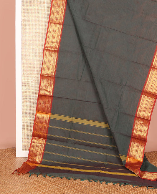 Green Plain Chettinad Cotton Saree, Complemented by a Contrast Traditional Motifs Woven Zari Temple Border, and Subtly Striped Pallu