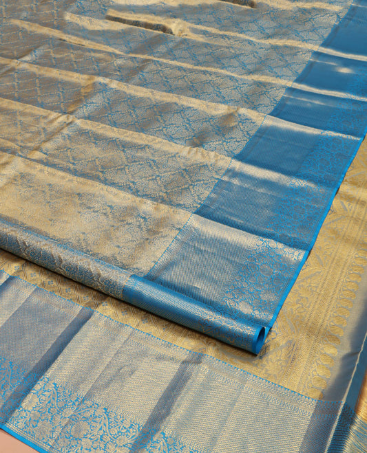 Blue Kanchipuram Silk Saree, Mesmerized with Zari Jacquard Design All Over Its Body, Highlighted by a Zari Border of Thilakam, Muthu, Kathir, Diamond, and Floral Designs, and Pallu of Jaal Designs, and Paired with a Matching Blouse