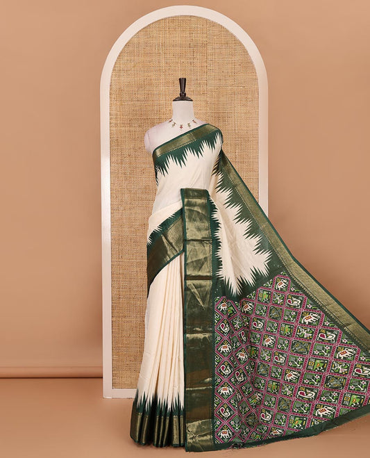 Cream-green plain dola-tussar saree, contrast temple zari border, patola animal motifs enclosed jaal printed pallu & patola printed blouse