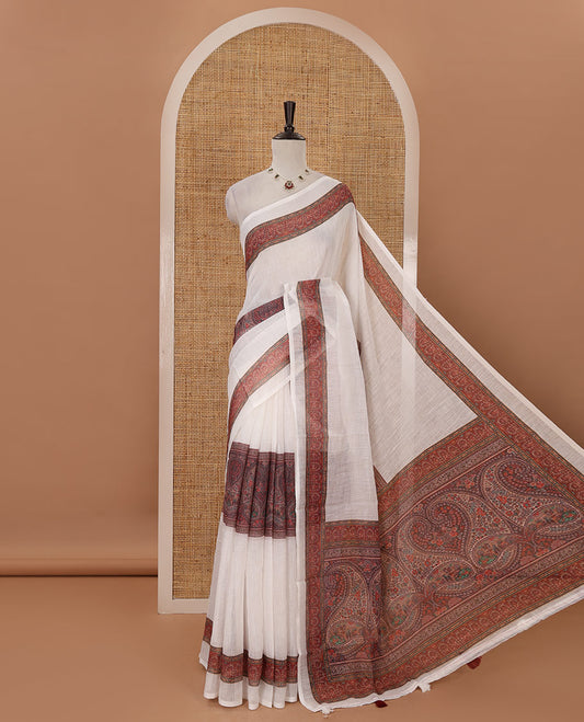 White half-plain & half-printed linen cotton saree, brown-color printed border, paisley motifs printed pallu & uniquely printed blouse