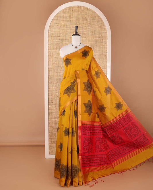 Mustard six-petal-like leaf motifs printed micro-silk saree, copper zari border, contrast intricate pallu & plain red blouse