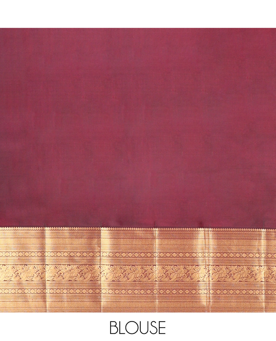 Pink Vasundhara Silk Saree, Beautifully Bedecked with Zari Stripes on Its Body, Complemented by a Contrast Border of Thilakam Mokku, Kathir, Vanki, Mayil, and Laddu Kamalam Designs, Majestically Detailed Jaal Pallu, and Paired with a Contrast Blouse