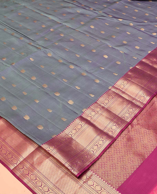 Grey Vasundhara Lite Silk Mix Saree, Beautifully Bedecked with Zari Buttas All Over Its Body, Complemented by Contrast Border of Rekku, Muthu, Kodi Visiry, and Jaal Designs, Grand Pallu and Paired with a Contrast Blouse