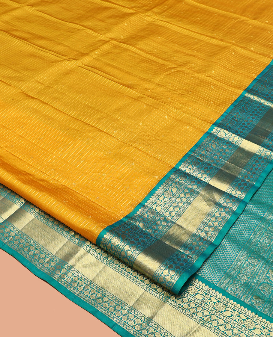 Yellow Vasundhara Silk Saree, Subtly Sparkled with Zari Buttas and Checks All Over Its Body, Complemented by a Contrast Border of Thilakam, Diamond, Kodi Visiry, and Poun Designs, Grand Pallu, and Paired with a Contrast Blouse